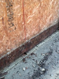 OSB ran to the cement and was then bricked over