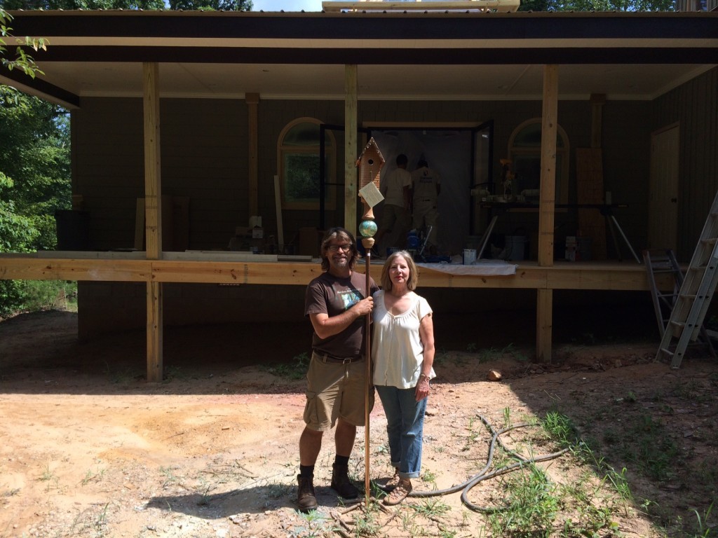 David and Julie stand with one of their famous birdhouses in front of the tasting room which is soon to be finished.