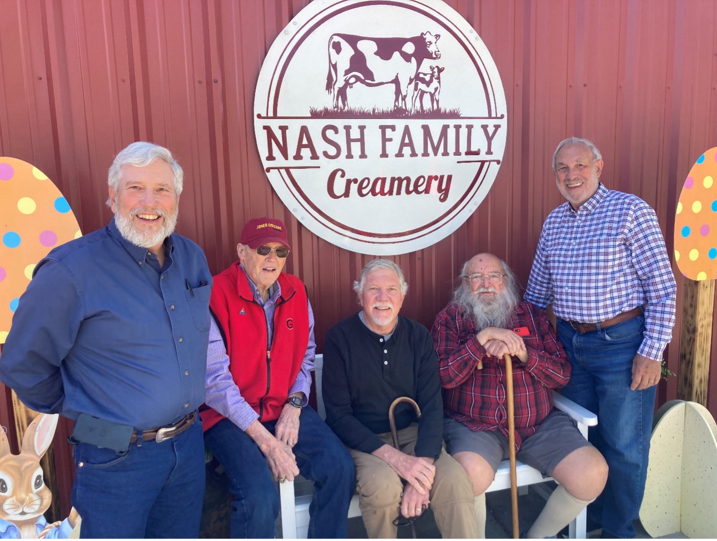 John Bernard, Larry Guthrie, Joe West, Lane Ely and Warren Gilson in front of Nash Family Creamery Sign on Red Barn Wall