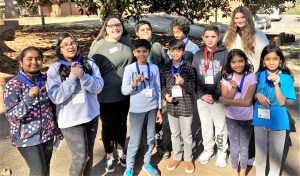 A group of youth holding their award medals