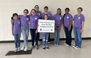 A group of students and adults pose for a picture.