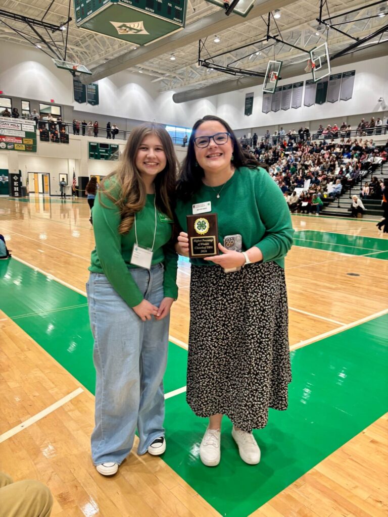 4-H'er and 4-H Agents show off the Highest Percentage of Winner plaque. 