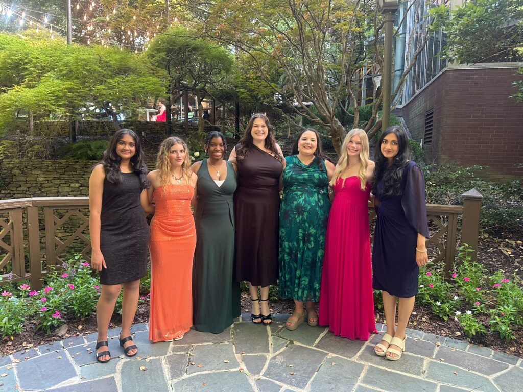 Students with their 4-H leaders in banquet dresses.