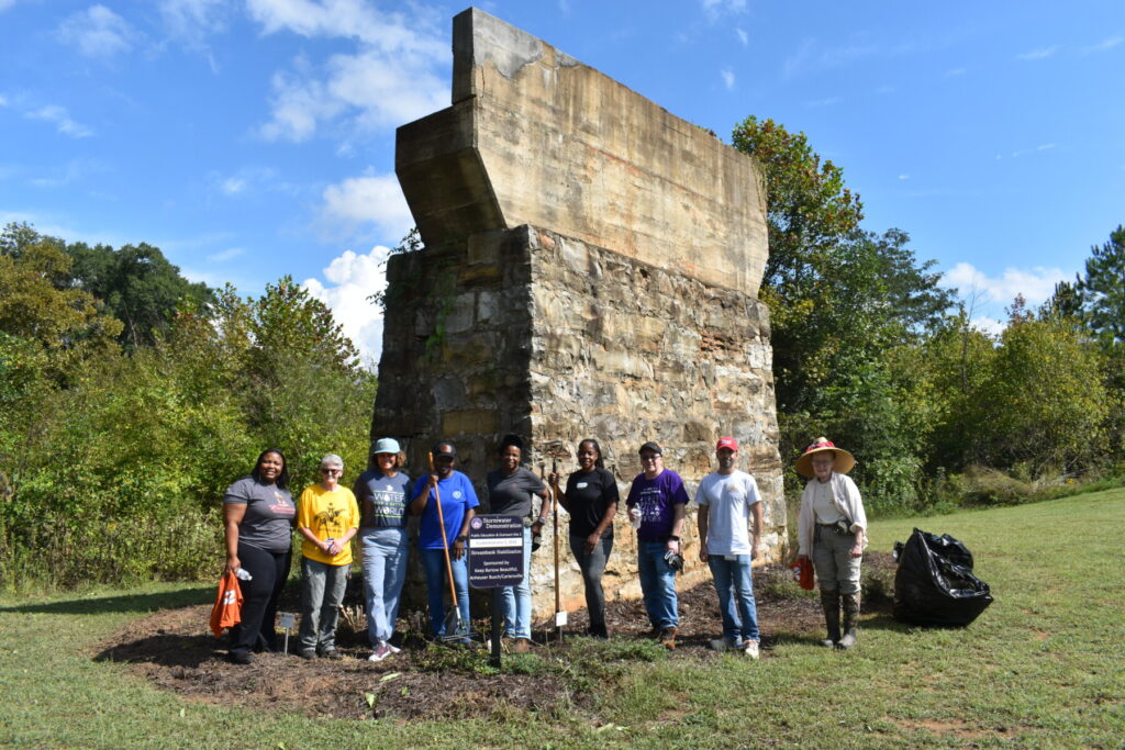 Group photo of volunteers in front of Hardin Bridge Garden they cleaned up