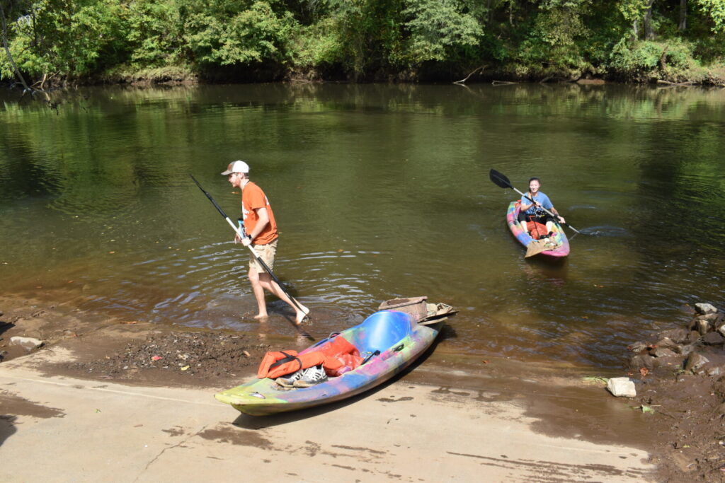 Volunteers exiting the river after cleaning up