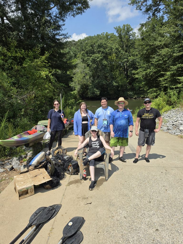 Group photo of volunteers with trash collected 