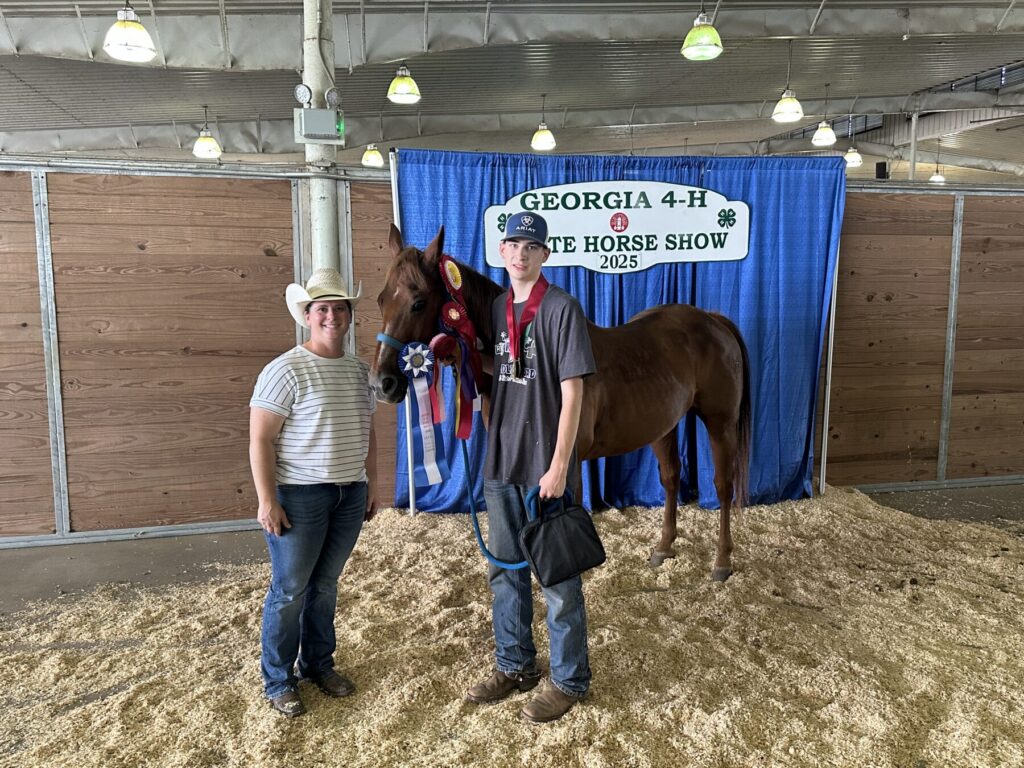 two people standing next to a horse