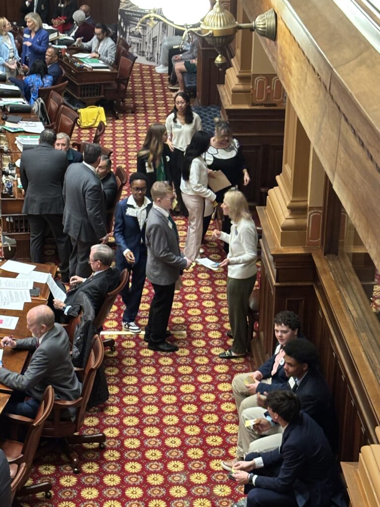 Group of people standing on the floor talking
