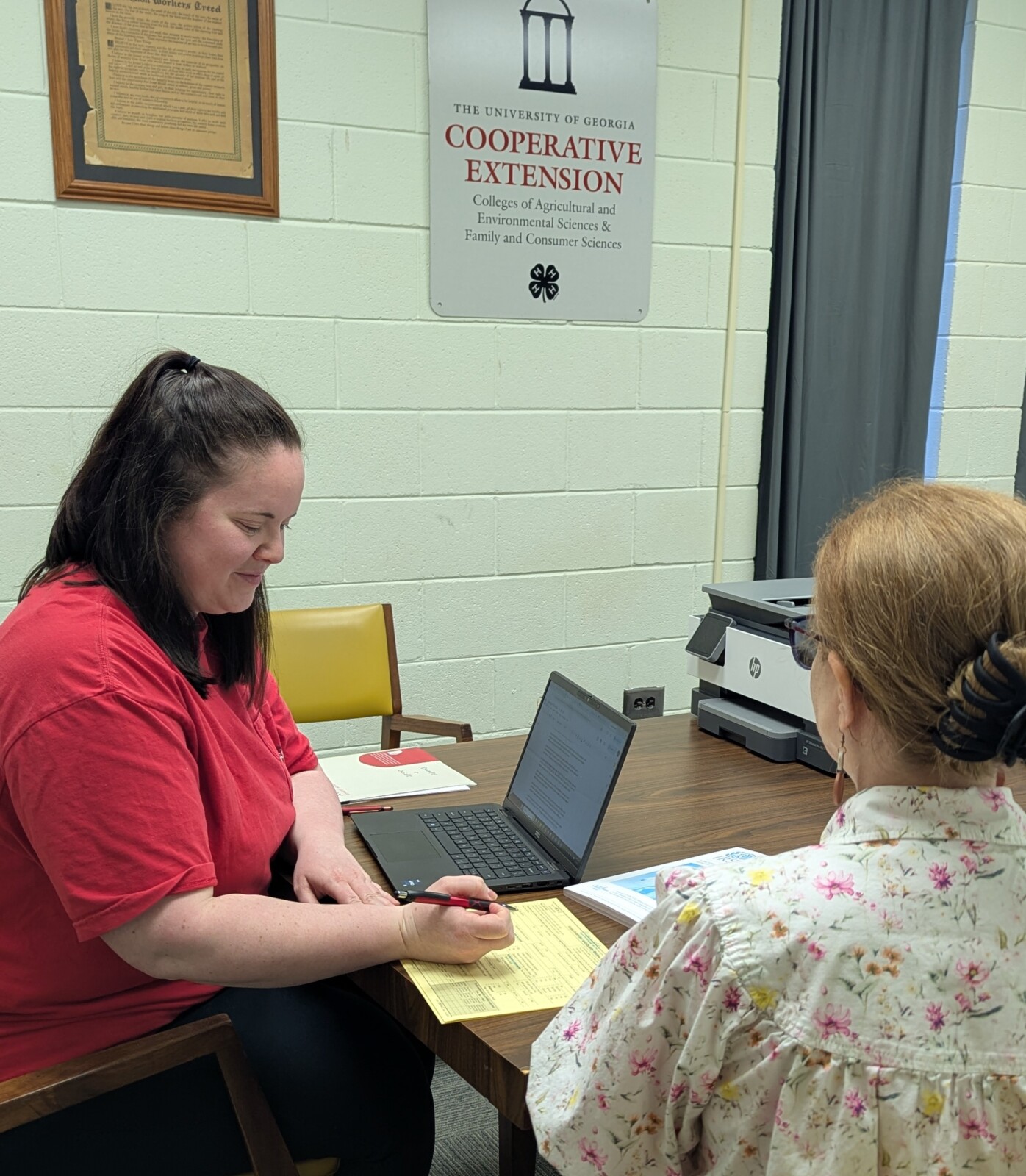 FACS Agent, Emily Williams, and client sitting working on taxes